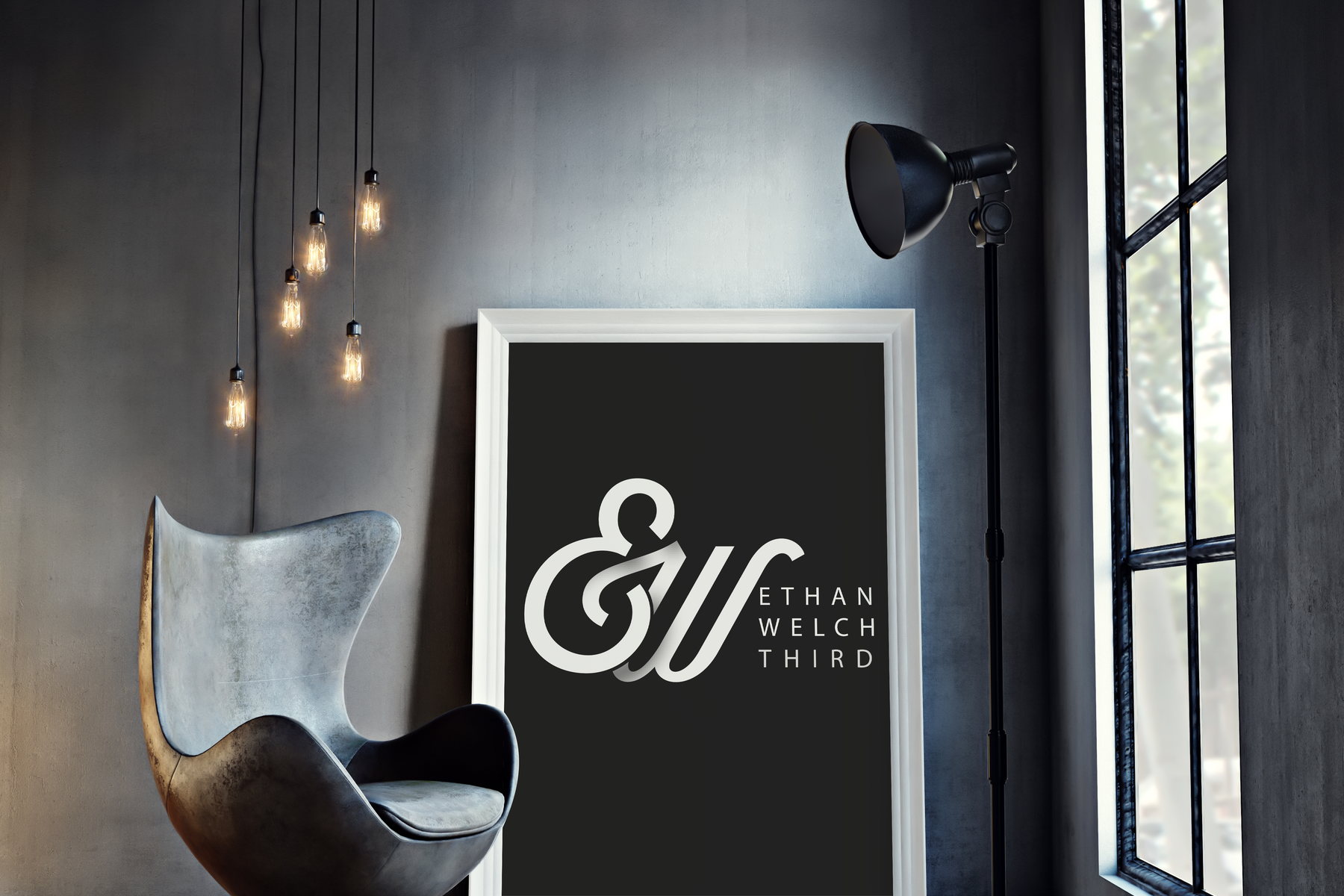 The chosen ampersand monogram with the stacked wordmark, framed and leaning against a concrete wall